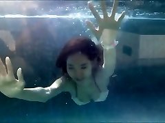 Young Asian Girl in Luxurious Bathing Suit at a Swimming Pool