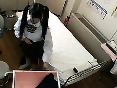 Cute Asian schoolgirl with ponytails has a doctor fingering 