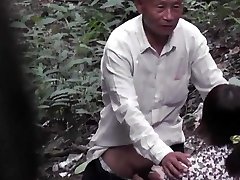 Grandpa With Asian Prostitute In The Forest