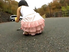 Asian teen bends over and shows horny upskirt in the street