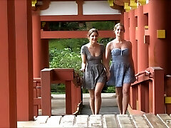 Lesbian duo kissing and flashing at a Japanese temple