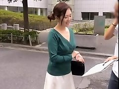 Friendly Asian nymph keeps sneering while her cleavage is totally revealed