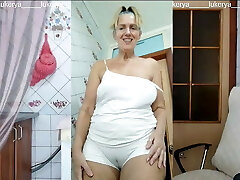 Lukerya in the kitchen in wet white panties, bottom view