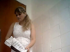 Fine curvaceous blonde lady in white dress filmed in the toilet room