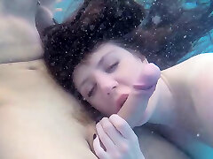Super ultra-cute babe gives eager blowjob under the water