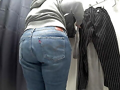 In a fitting room in a public store, the camera caught a chubby milf with a super-sexy ass in semitransparent panties. PAWG.