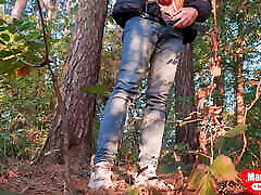 Guy pissing in the forest under a tree